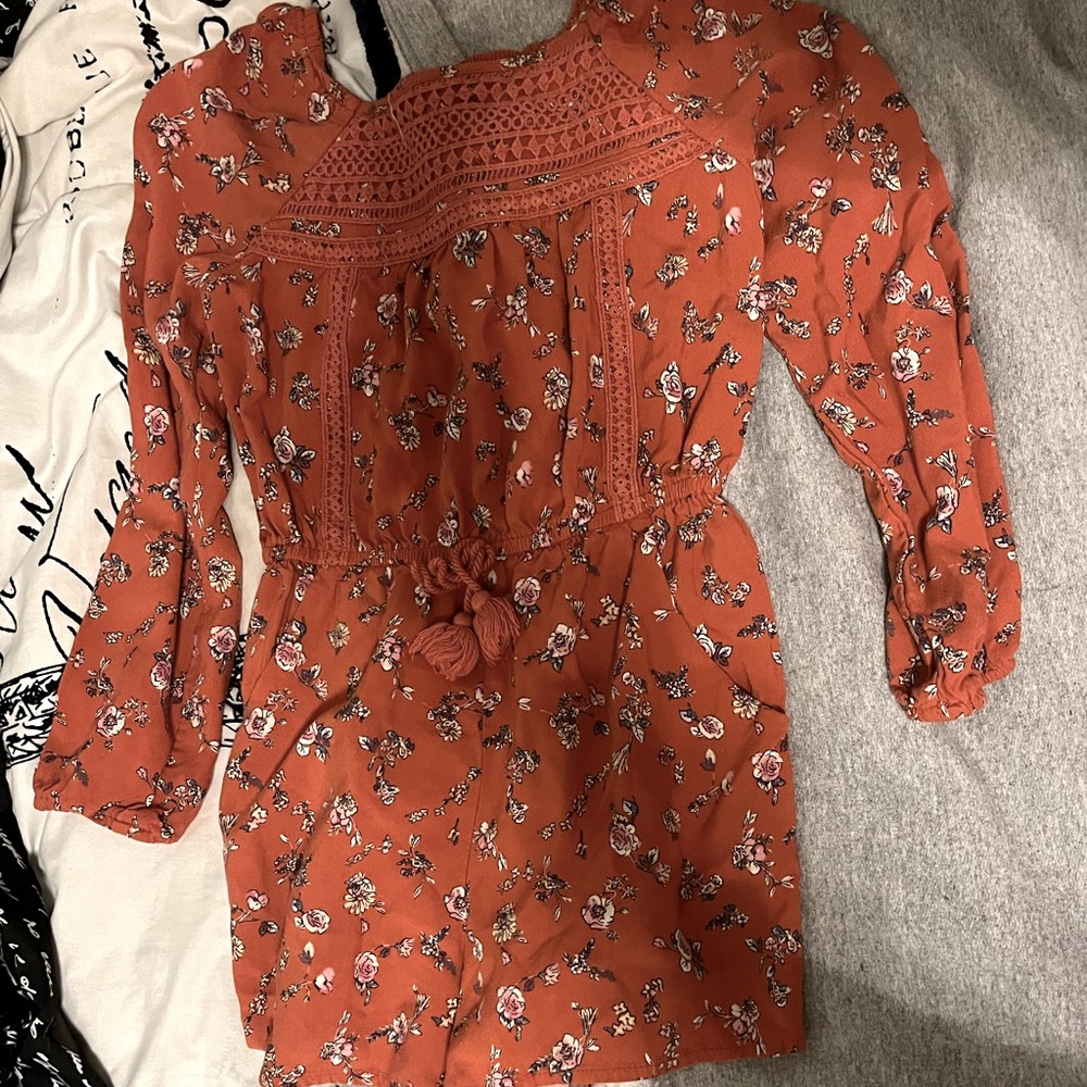 Red-orange rompa with floral design